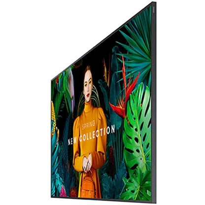 An ultra-slim 65 inch Samsung QM65C non-glare commercial signage monitor mounted flush on a contemporary corporate conference room wall in landscape orientation