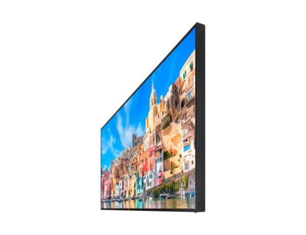A panoramic 105 inch Samsung LH105QMDNC/UE 5K display mounted flush on a feature wall in an executive boardroom displaying an ultrawide Microsoft Teams Front Row collaboration window